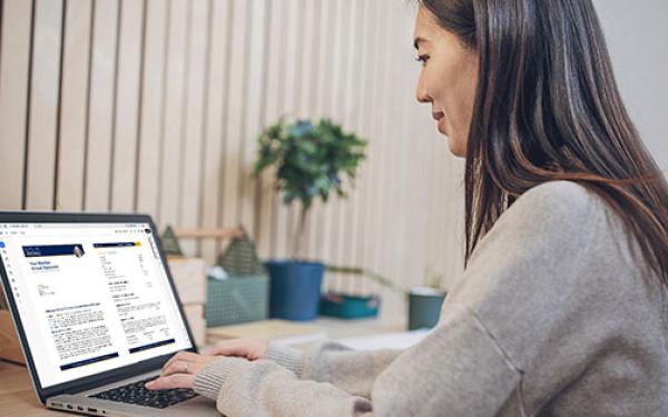 Woman looking at Member Annual Statement on laptop