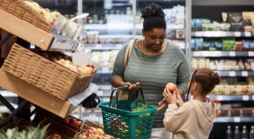 family shopping in the produce section of the grocery store